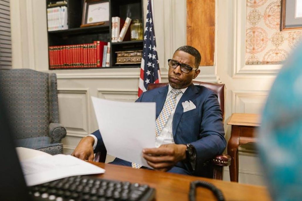 A defense attorney meeting with a client at the office